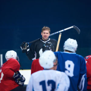 ice hockey players team group meeting with trainer  in sport arena indoors